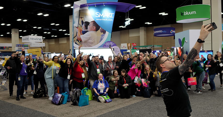A group photo taken at the SMART Technologies booth.