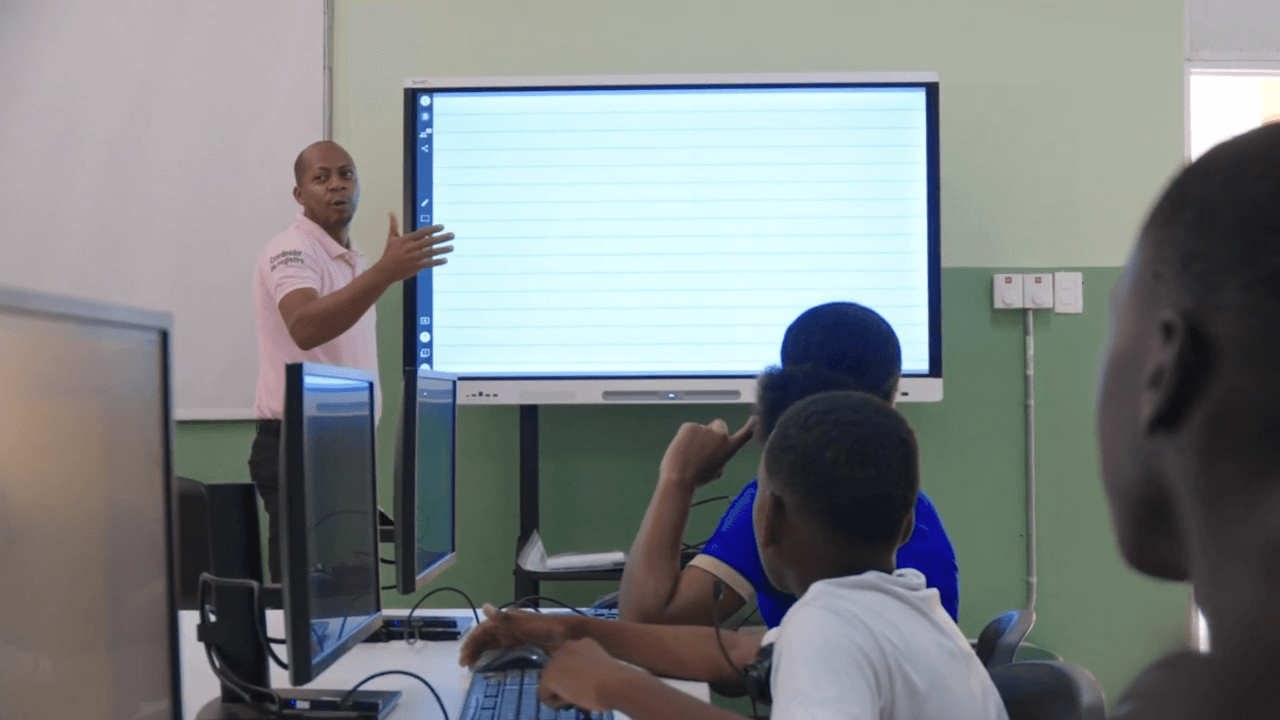 Dominican Republic teacher at a SMART Board with class